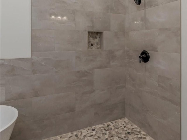 full bath with a tile shower and a soaking tub