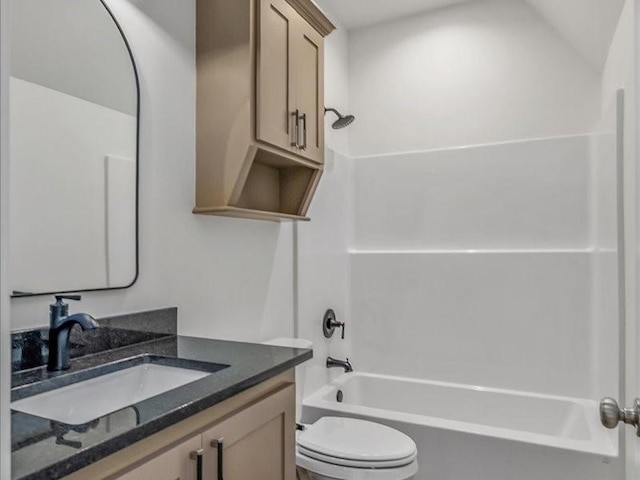 bathroom featuring shower / bathing tub combination, toilet, and vanity