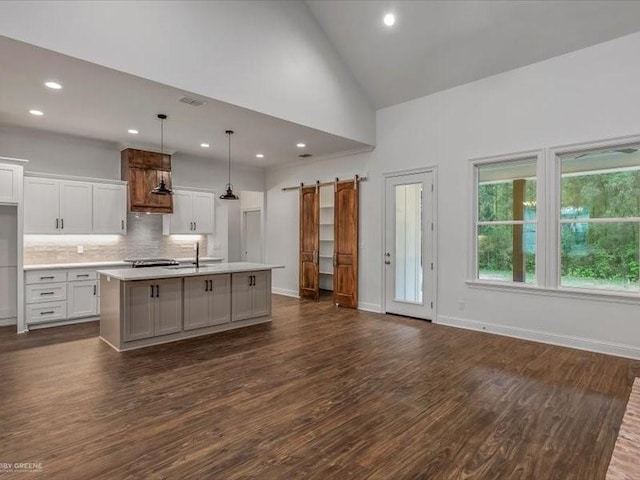 kitchen featuring high vaulted ceiling, tasteful backsplash, light countertops, dark wood finished floors, and white cabinetry