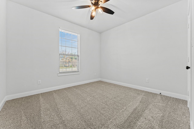 spare room featuring carpet floors, a ceiling fan, and baseboards