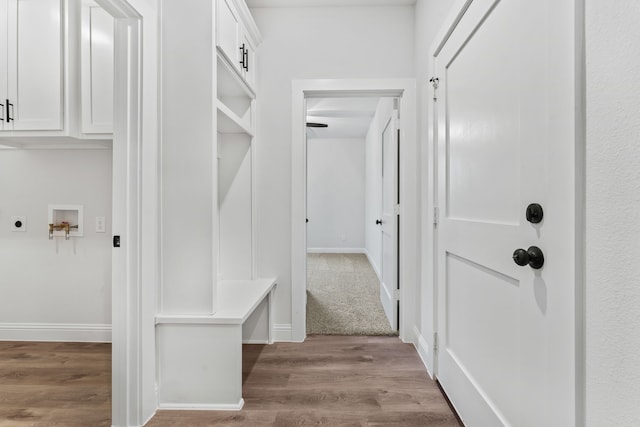 mudroom with baseboards and wood finished floors
