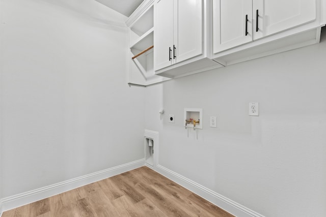 laundry area featuring light wood-type flooring, baseboards, hookup for a washing machine, cabinet space, and electric dryer hookup