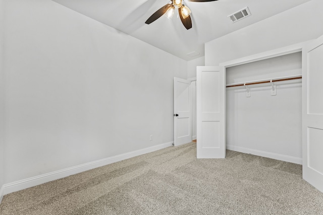 unfurnished bedroom with visible vents, a ceiling fan, a closet, baseboards, and carpet flooring