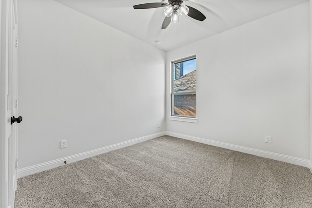 carpeted empty room with baseboards and a ceiling fan