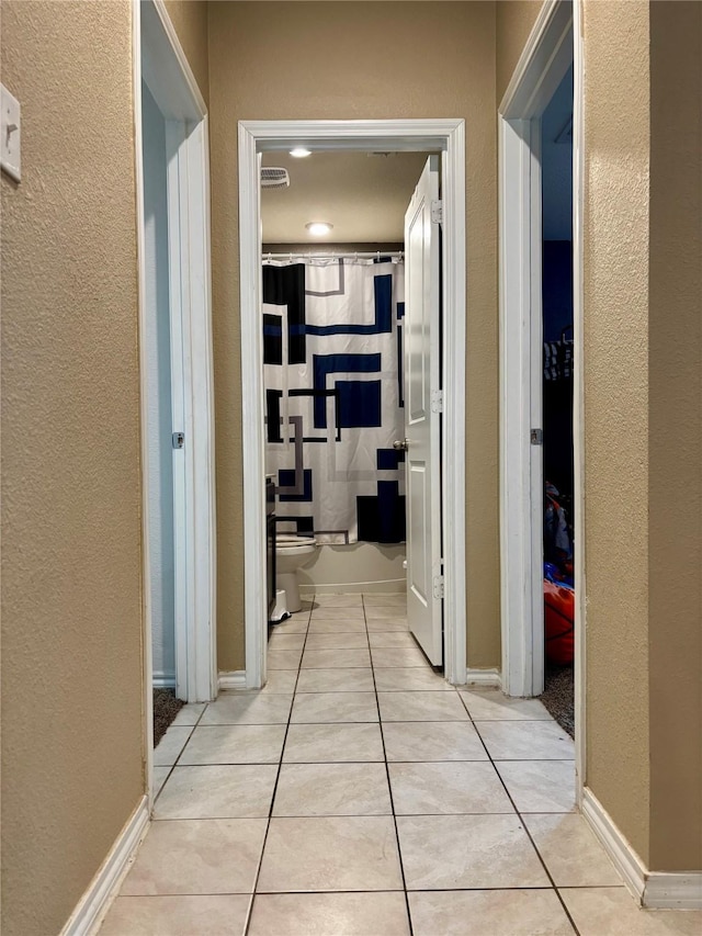 828 Costlow Ln, Fate, TX 75189 - hallway featuring light tile patterned floors and a textured wall