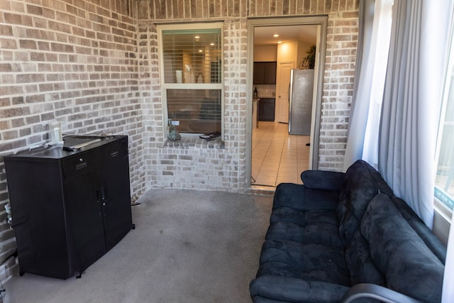 828 Costlow Ln, Fate, TX 75189 - living area featuring brick wall and light colored carpet