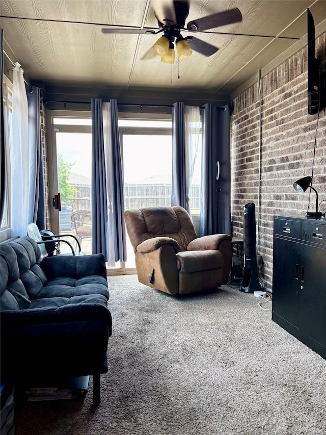 828 Costlow Ln, Fate, TX 75189 - carpeted living area featuring ceiling fan and brick wall