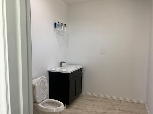 818 Rd 5607, Cleveland, TX 77327 - bathroom featuring toilet, vanity, and baseboards