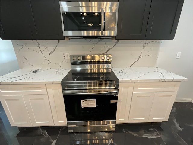818 Rd 5607, Cleveland, TX 77327 - kitchen with white cabinets, stainless steel appliances, marble finish floor, and tasteful backsplash