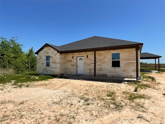 818 Rd 5607, Cleveland, TX 77327 - back of property with stone siding and a shingled roof
