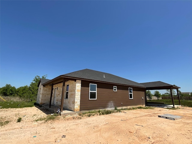 818 Rd 5607, Cleveland, TX 77327 - view of property exterior with stone siding, a gazebo, and roof with shingles