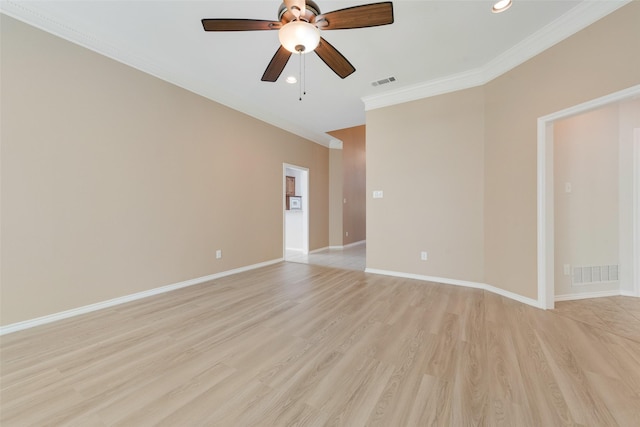 unfurnished room featuring a ceiling fan, ornamental molding, light wood finished floors, and visible vents
