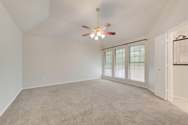 spare room featuring carpet floors, a ceiling fan, and baseboards