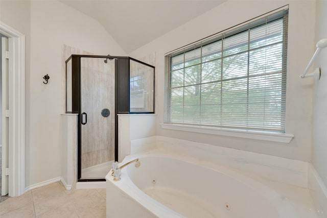 bathroom with tile patterned flooring, a tub with jets, lofted ceiling, and a stall shower