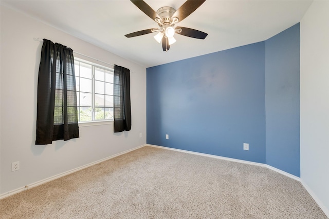 unfurnished room featuring carpet, baseboards, and ceiling fan