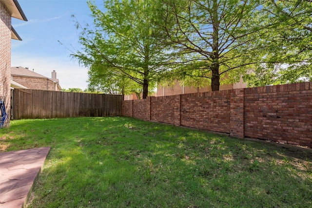 view of yard with a fenced backyard