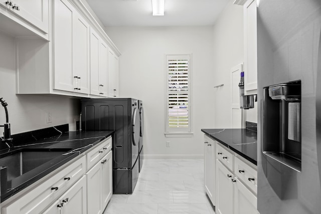 laundry area with washing machine and dryer, cabinet space, marble finish floor, and a sink