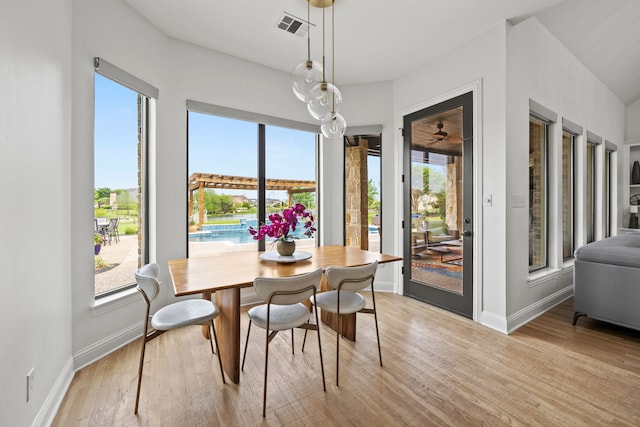 dining area with light wood-style flooring, visible vents, and baseboards