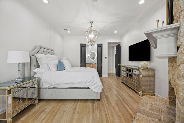 bedroom with recessed lighting, light wood finished floors, crown molding, and a notable chandelier