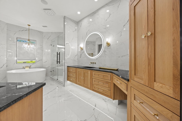 bathroom featuring a freestanding tub, marble finish floor, vanity, and a marble finish shower