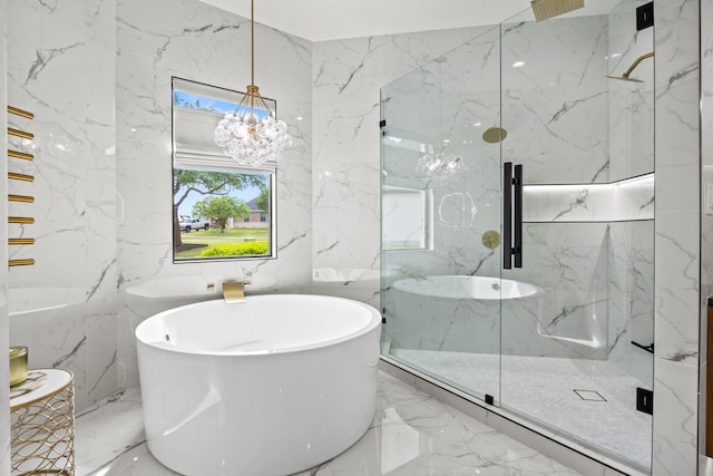 full bath with a soaking tub, stone wall, marble finish floor, and a marble finish shower