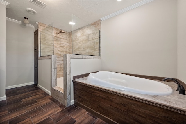 bathroom with visible vents, ornamental molding, a garden tub, wood tiled floor, and a walk in shower