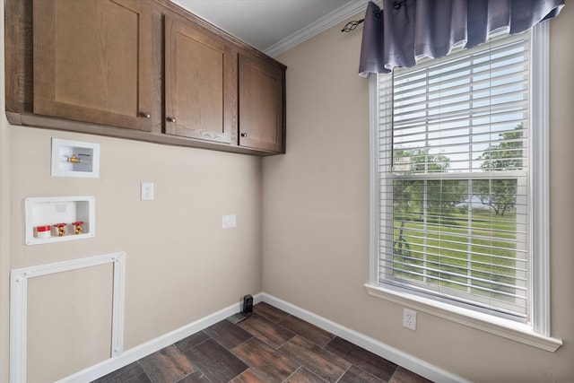 laundry area featuring crown molding, hookup for a washing machine, plenty of natural light, cabinet space, and baseboards
