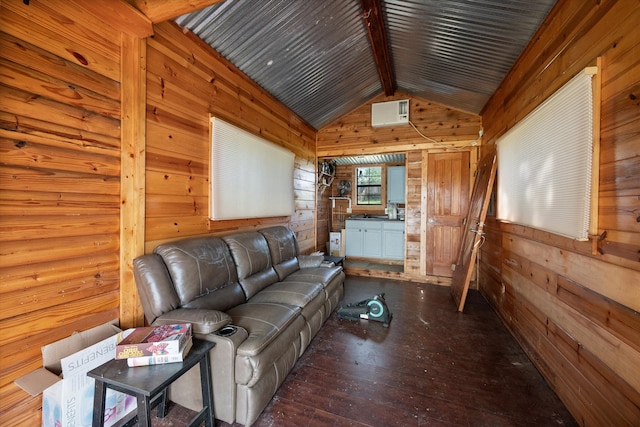 living area with vaulted ceiling with beams, wood walls, and hardwood / wood-style flooring