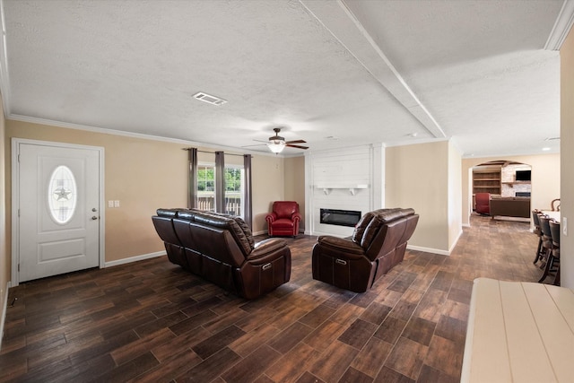 living room with a ceiling fan, arched walkways, a fireplace, baseboards, and visible vents