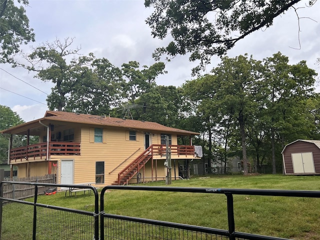 113 Daniel Dr, Mabank, TX 75156 - rear view of house with a storage unit, a fenced backyard, a lawn, stairs, and an outdoor structure