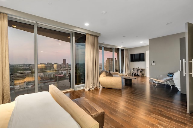 bedroom featuring floor to ceiling windows, hardwood / wood-style flooring, access to outside, and recessed lighting