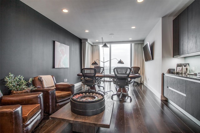 living area featuring baseboards, recessed lighting, and dark wood-style flooring