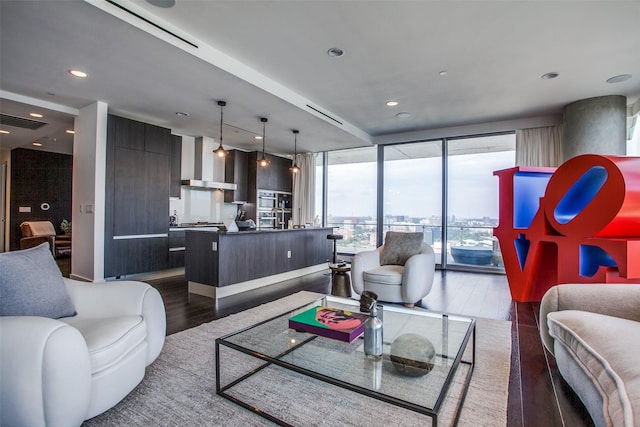 living room with dark wood finished floors, expansive windows, visible vents, and recessed lighting