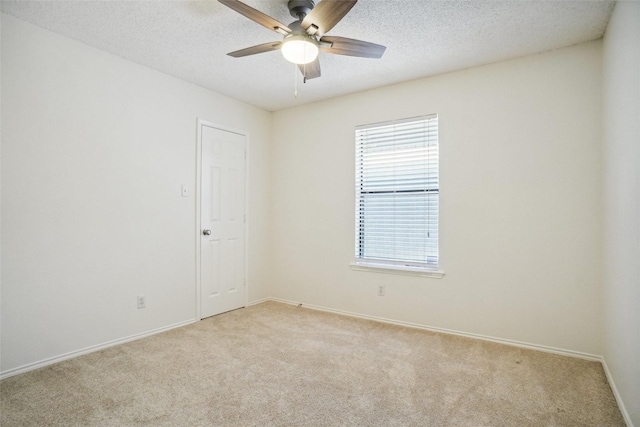 empty room with light carpet, baseboards, and ceiling fan
