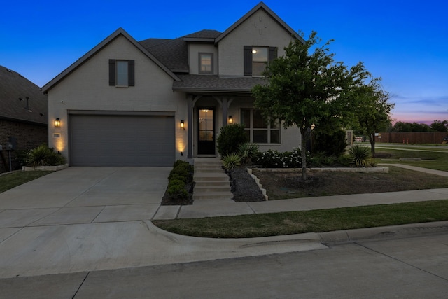 traditional-style home with an attached garage, a shingled roof, driveway, and brick siding