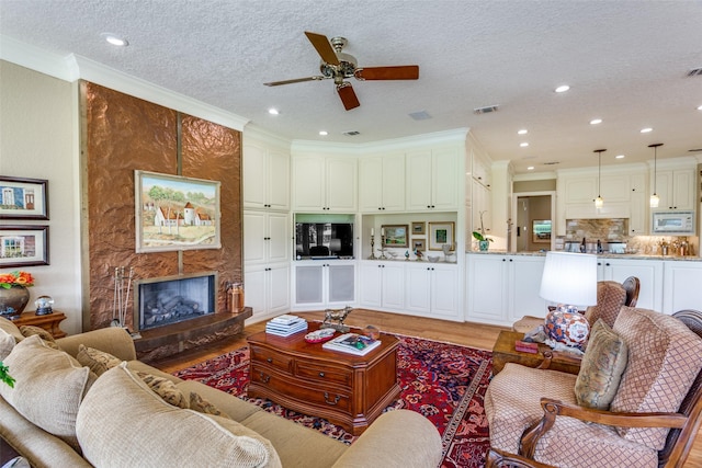 6001 Laurel Valley Ct, Fort Worth, TX 76132 - living area with light wood-style flooring, ceiling fan, a fireplace, recessed lighting, and crown molding