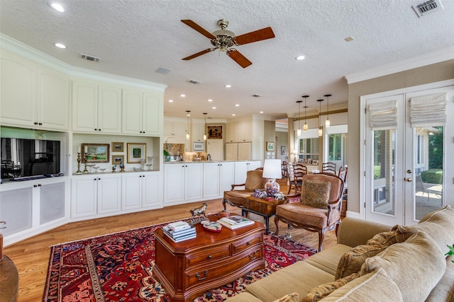 6001 Laurel Valley Ct, Fort Worth, TX 76132 - living area featuring light wood-type flooring, a ceiling fan, crown molding, a textured ceiling, and recessed lighting
