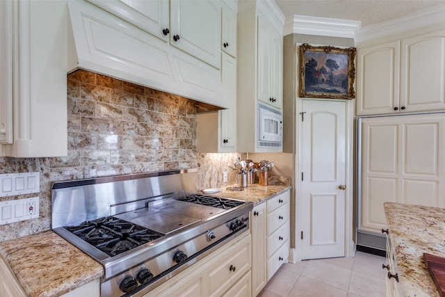 6001 Laurel Valley Ct, Fort Worth, TX 76132 - kitchen featuring stainless steel gas cooktop, premium range hood, light tile patterned floors, tasteful backsplash, and ornamental molding
