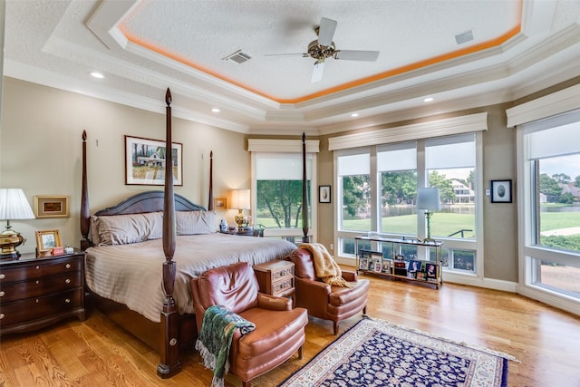 6001 Laurel Valley Ct, Fort Worth, TX 76132 - bedroom featuring a tray ceiling, multiple windows, wood finished floors, and ornamental molding
