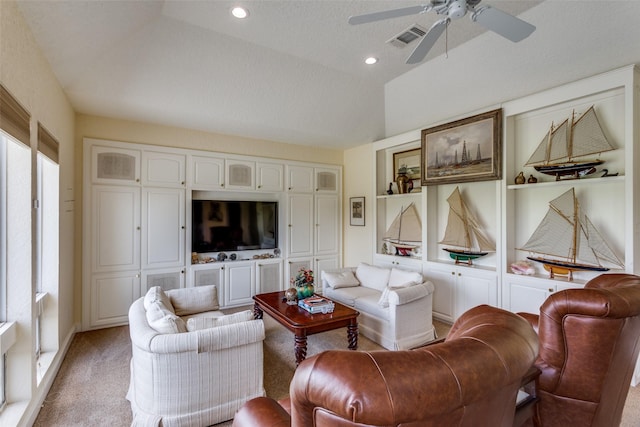 6001 Laurel Valley Ct, Fort Worth, TX 76132 - living area featuring built in shelves, a ceiling fan, light colored carpet, a textured ceiling, and vaulted ceiling