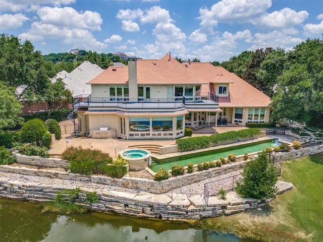 6001 Laurel Valley Ct, Fort Worth, TX 76132 - back of property with an in-ground hot tub, a patio area, a balcony, and a water view