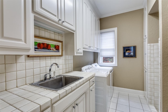 6001 Laurel Valley Ct, Fort Worth, TX 76132 - washroom featuring washing machine and dryer, cabinet space, light tile patterned floors, and ornamental molding