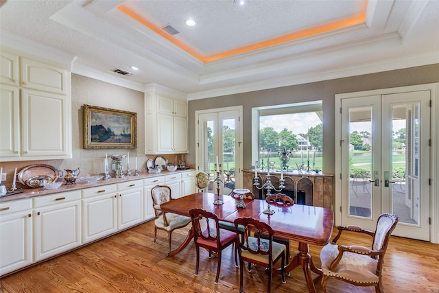 6001 Laurel Valley Ct, Fort Worth, TX 76132 - dining room featuring french doors, a raised ceiling, light wood-style flooring, crown molding, and recessed lighting