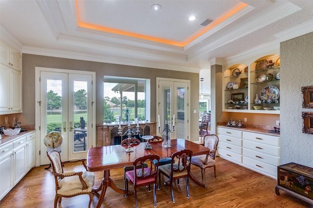 6001 Laurel Valley Ct, Fort Worth, TX 76132 - dining area with french doors, a tray ceiling, ornamental molding, and light wood-type flooring