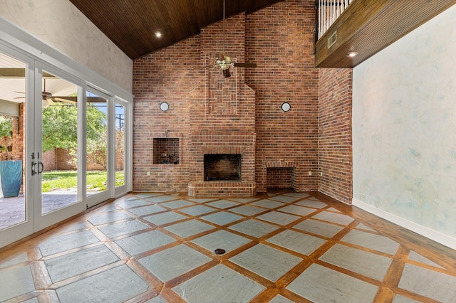 unfurnished living room featuring wooden ceiling, baseboards, a brick fireplace, high vaulted ceiling, and brick wall