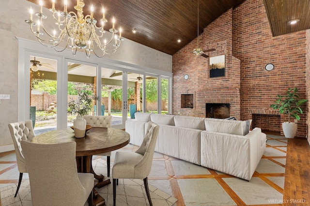 interior space featuring french doors, wood ceiling, a fireplace, high vaulted ceiling, and brick wall