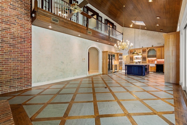 interior space featuring recessed lighting, arched walkways, wood ceiling, high vaulted ceiling, and ceiling fan with notable chandelier