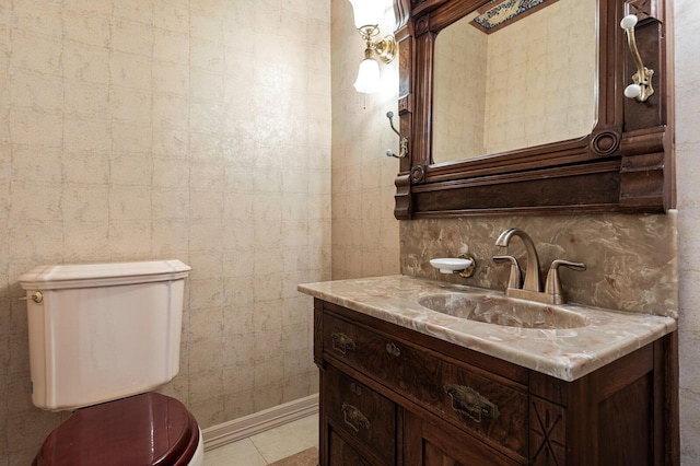 half bathroom featuring toilet, tasteful backsplash, vanity, and tile walls