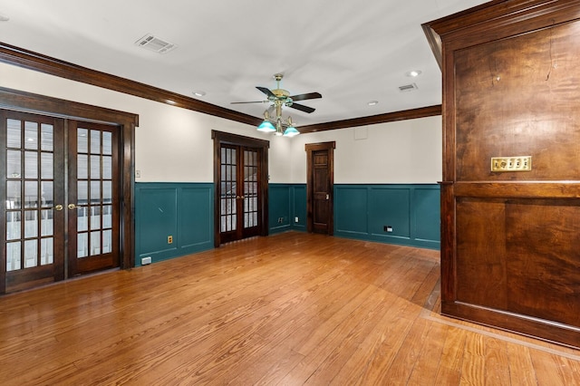 unfurnished room featuring french doors, visible vents, a ceiling fan, and crown molding