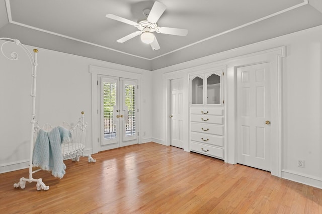 interior space featuring access to exterior, light wood finished floors, baseboards, and french doors
